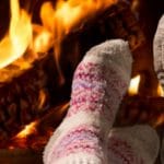 Couple relaxing at the fireplace on winter evening